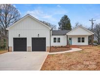 Charming home features a two-car garage and a welcoming light-blue front door at 719 S Franklin St # 2, China Grove, NC 28023