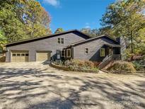 Charming home with a two-car garage and mature landscaping and driveway with trees at 775 Bridgewood Dr, Rock Hill, SC 29732