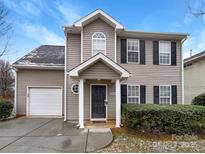Charming two-story home with a welcoming entrance and attached garage for convenient parking at 8005 Mcgarry Trl, Charlotte, NC 28214