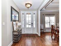 Welcoming foyer featuring hardwood floors and a stylish entryway table with decorative accents and a bright, glass-paneled front door at 816 Springs Rd, Dallas, NC 28034