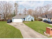 Charming blue home with a well-maintained lawn and a two-car garage with an extended driveway at 10736 Spruce Mountain Rd, Charlotte, NC 28214