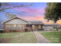 Charming brick home featuring a well-manicured front lawn and convenient carport at 2039 Bangor Rd # 12, Charlotte, NC 28217