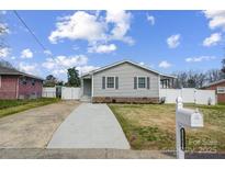 Charming single-story home showcasing a well-manicured lawn and a freshly poured concrete driveway at 2081 Montclair Dr, Rock Hill, SC 29732