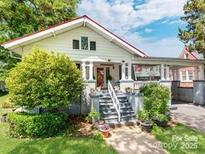 Charming home with landscaped front yard, covered porch and adjacent covered parking at 322 4Th Sw St, Hickory, NC 28602