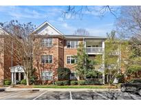 Inviting brick condo building with well-maintained landscaping and ample parking at 5601 Fairview Rd # 24, Charlotte, NC 28209