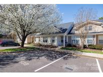 Inviting condo exterior with blooming tree, parking, and well-maintained landscaping on a sunny day at 639 Fawnborough Ct, Rock Hill, SC 29732