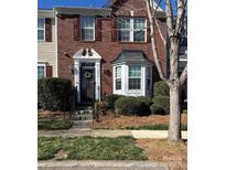 Charming brick townhome featuring a classic design, bay window, and inviting entrance at 6410 Hasley Woods Dr, Huntersville, NC 28078