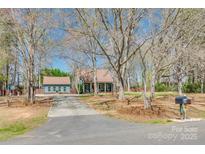 Charming home with mature trees, long driveway, and a detached garage, blending comfort with natural beauty at 6688 Pine Forest Dr, York, SC 29745