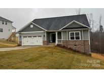 Charming single-story home with stone accents, a two-car garage, and well-manicured lawn at 111 High Rock Ct # 10, Statesville, NC 28677