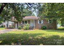 Charming single-story brick home with a covered carport and well-maintained front yard at 1327 Crestview Dr, Shelby, NC 28150