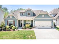 Charming home with a two-car garage, complemented by a well-manicured lawn and tasteful landscaping at 152 Broadleaf Dr, Denver, NC 28037