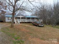 Charming single-story home with a cozy front porch and a metal roof at 160 Icard Ridge Rd, Granite Falls, NC 28630