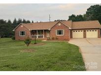 Charming single-story brick home features a well-manicured lawn and a welcoming front porch at 1922 Dogwood Flower Ln, Lincolnton, NC 28092