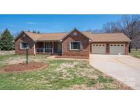 Charming brick home with a two-car garage, cozy porch, and well-maintained front yard at 1922 Dogwood Flower Ln, Lincolnton, NC 28092