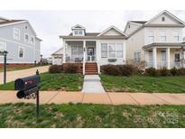 Charming cottage-style home with a welcoming front porch and well-manicured lawn at 23128 Goose Down Ln, Lancaster, SC 29720