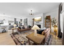 Bright, open living room featuring a decorative fireplace and large rug, filled with inviting, comfy furniture at 4114 Rutgers Ave, Charlotte, NC 28206