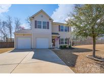 Charming two-story home featuring a two-car garage and well-maintained front yard with lush landscaping at 4314 Penrose Ct, Clover, SC 29710