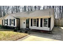 Charming one-story home with white siding, black shutters, and well-maintained landscaping at 4342 Valeview Ln, Charlotte, NC 28269