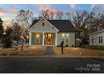 Charming single-story home with green siding and welcoming front porch at 501 Everette St, Monroe, NC 28112