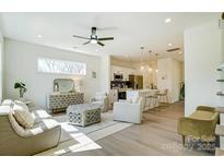 Bright living space with stylish furnishings, ceiling fan, and an open floor plan connecting to the kitchen at 709 Catawba St, Lincolnton, NC 28092