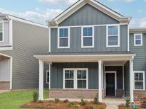 Charming two-story home featuring a covered front porch and gray siding at 105 Ciara Pl # E, Mooresville, NC 28117