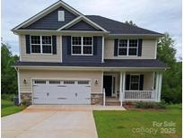 Charming two-story home featuring a covered porch, two-car garage, and beautiful contrasting siding at 145 High Rock Ct # 03, Statesville, NC 28677