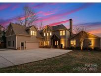 Stunning two-story home featuring a spacious driveway, attached garage and classic architectural details at 213 Morgan Bluff Rd, Mooresville, NC 28117
