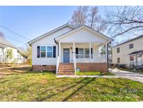 Charming exterior view of a cozy home with a welcoming front porch and brick accents at 248 Kerr Nw St, Concord, NC 28025