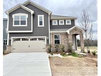 Charming two-story home featuring a two-car garage, stone accents, and classic architectural details at 2639 Tillman St, Monroe, NC 28112