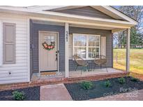 Inviting front porch with seating and a decorative wreath on the front door for a warm and welcoming entrance at 327 Berry St, Rock Hill, SC 29732