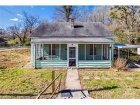 Charming bungalow with a screened porch and a covered carport, offering a blend of comfort and convenience at 36 Brookline St, Great Falls, SC 29055