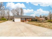 Charming brick ranch home featuring a spacious driveway and attached garage at 4014 Linwood Rd, Gastonia, NC 28052