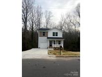 Charming two-story home featuring a covered porch, attached garage, and landscaped yard at 421 Rocky Brook Dr, Shelby, NC 28150