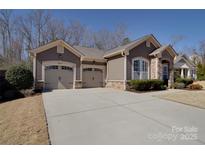 This single-story home showcases a double garage and a well-maintained front yard at 5017 Willing Ct # 124, Indian Land, SC 29707