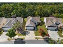 Aerial view of a well-maintained suburban home with manicured lawns and mature trees at 8107 Crater Lake Dr, Indian Land, SC 29707