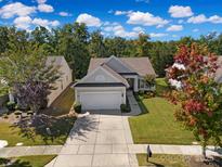 Charming single-story home with a two-car garage, manicured lawn, and mature trees at 8107 Crater Lake Dr, Indian Land, SC 29707