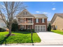 Charming two-story brick home featuring a welcoming front porch and well-maintained landscaping at 1016 Forbishire Dr, Matthews, NC 28104