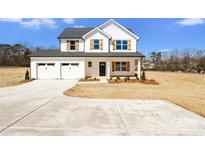 Charming two-story home featuring a two-car garage and manicured landscaping at 1044 Margrace Rd, Kings Mountain, NC 28086