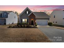 Charming single-Gathering home with well-manicured lawn and inviting curb appeal at dusk at 10714 Sapphire Trl, Davidson, NC 28036