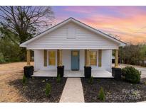 Charming home featuring new landscaping, rustic wood accents and a welcoming covered front porch at 108 Arlene Ave, Kannapolis, NC 28081