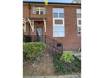 Charming brick townhome featuring a quaint front entrance and well-maintained landscaping at 121 Irving Ave, Mooresville, NC 28117