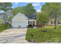 Charming home featuring a two-car garage, well-manicured lawn and inviting front entrance at 1336 Eisenhower Nw Pl, Concord, NC 28027