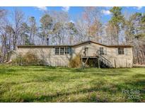 Charming single-story home featuring neutral siding and well-maintained front lawn at 2166 Hough Rd, Lancaster, SC 29720