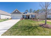 Charming single-story home featuring a manicured lawn, attached garage, and inviting front porch at 2455 Seagull Dr # 62, Denver, NC 28037