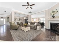 Open-concept living room featuring hardwood floors, neutral paint, and a cozy fireplace at 2455 Seagull Dr # 62, Denver, NC 28037