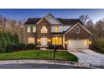 Charming two-story brick home with a well-manicured lawn and an attached two-car garage at 2835 Peverell Ln, Charlotte, NC 28270