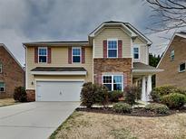 Charming two-story home featuring stone accents, a two-car garage, and well-maintained landscaping at 3420 Donnington Way, Gastonia, NC 28056