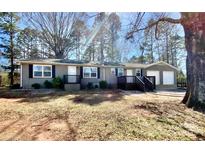 Charming single-story home featuring a two-car garage and inviting front porch with landscaped yard at 3807 Woodlawn St, Sharon, SC 29742