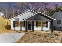 Charming home with white siding, black accents, and inviting front porch with well-lit entry for curb appeal at 42 Magnolia St, York, SC 29745