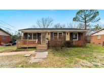 Charming single-story home with a cozy front porch and well-maintained lawn at 4914 Ridgeley Dr, Charlotte, NC 28208